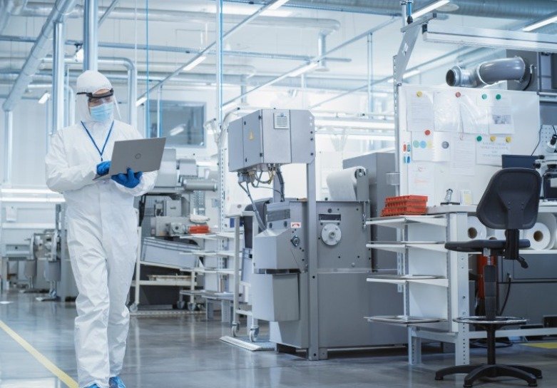 Person in lab coat with laptop