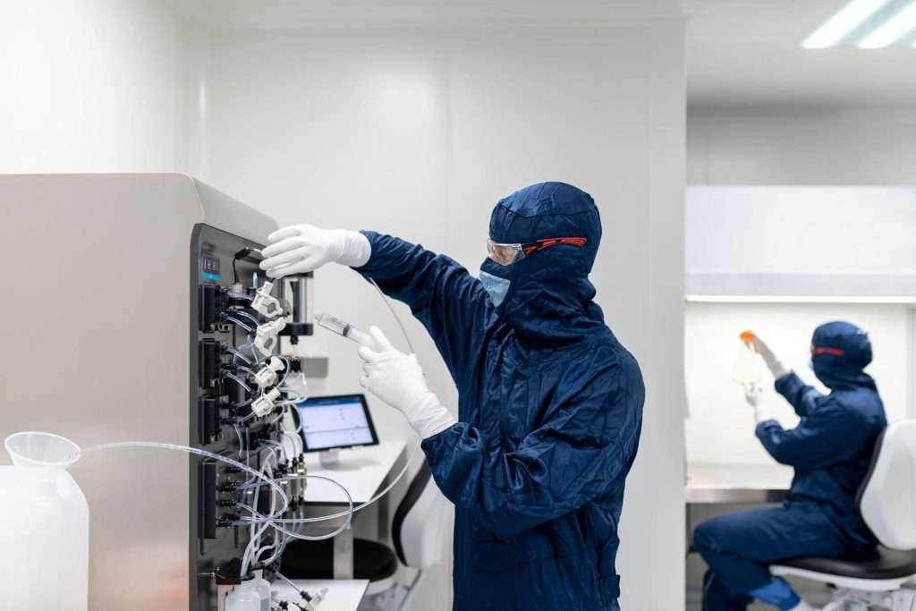 Laboratory workers in protective gear