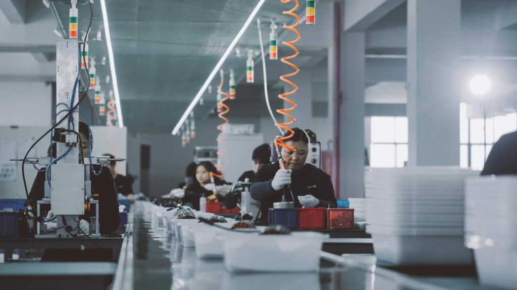 Workers in industrial assembly line